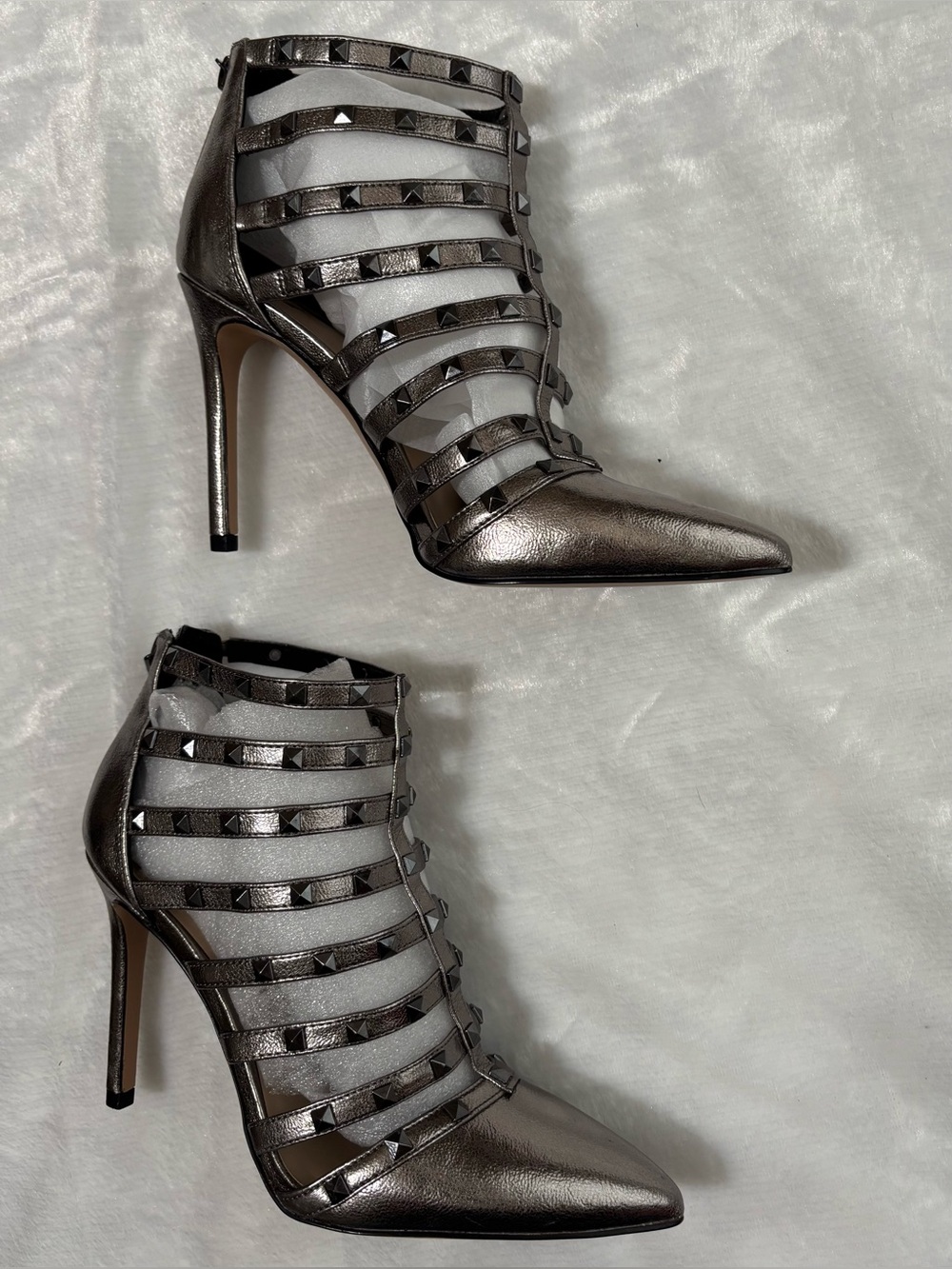 The Danela pewter studded strappy pointed-toe 3-3/4” heel bootie with zip-back